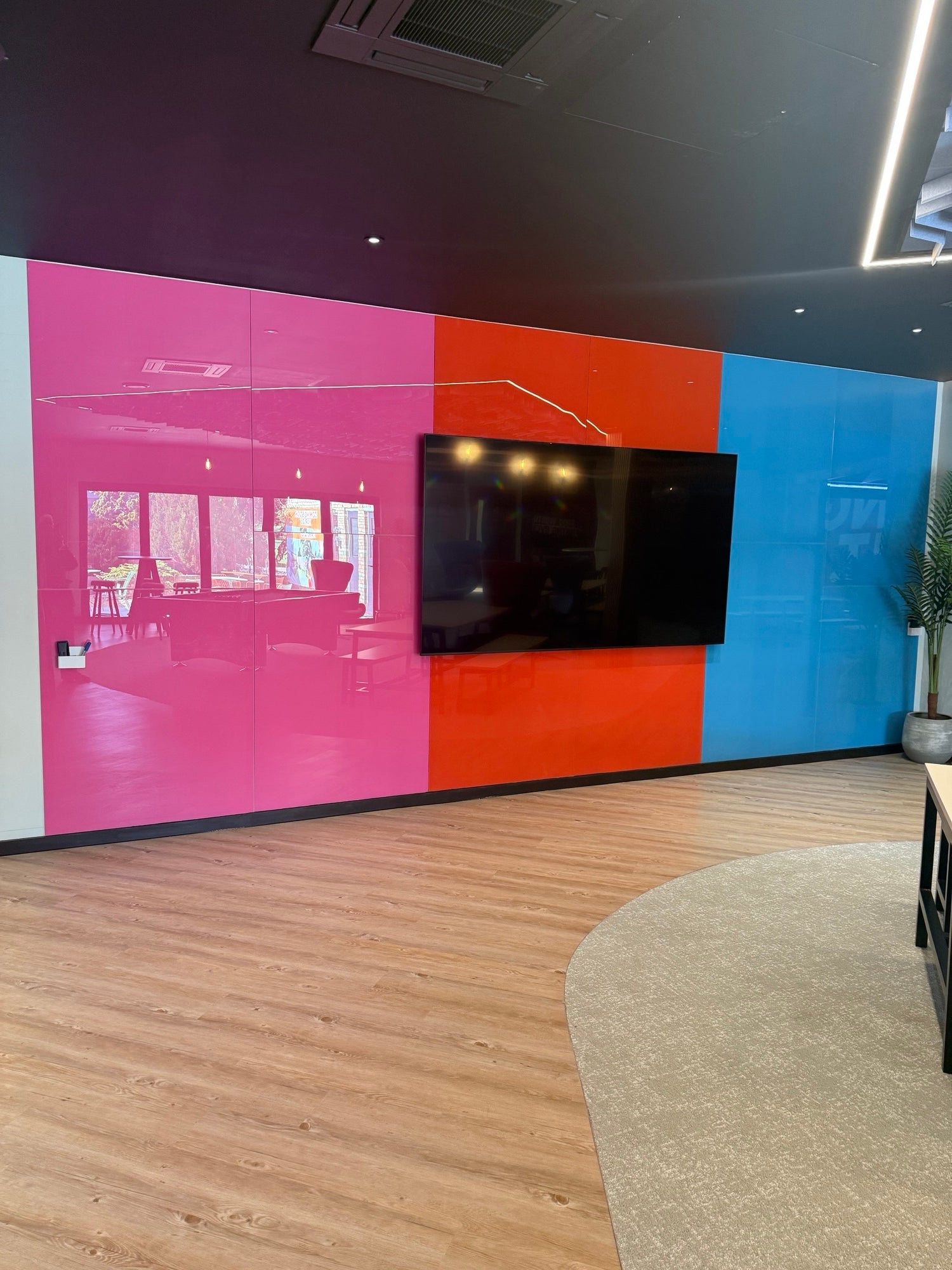 pink red and vivid blue bespoke glass writing boards in break out zone